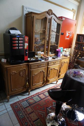 a room with wooden furniture and a large mirror at Hotel Asiris in Bruges
