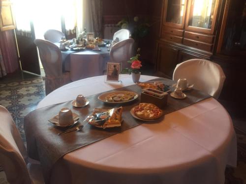 a table with plates of food on top of it at Casa Tonina in Carloforte