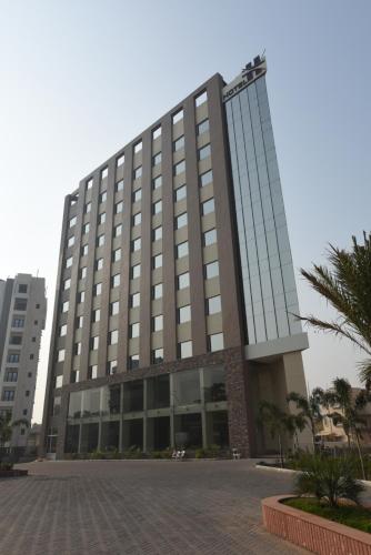 a large building with a lot of windows at Hotel H - Sandhill Hotels Private Limited in Anand