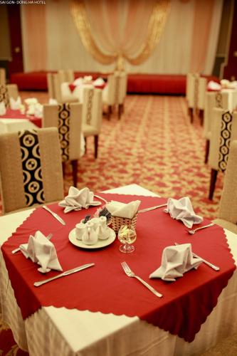 a table with a red table cloth and silverware on it at Sai Gon Dong Ha Hotel - a member of Saigontourist Group in Quảng Trị