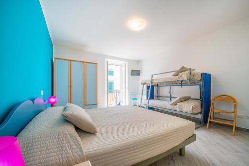 a bedroom with a bed and a bunk bed at Hotel Ristorante Crescenzo in Procida