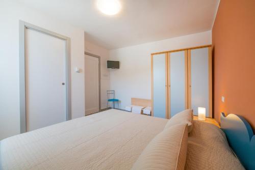 a bedroom with a large bed with an orange wall at Hotel Ristorante Crescenzo in Procida