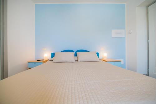 a large bed with two pillows on top of it at Hotel Ristorante Crescenzo in Procida