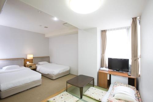 Un ou plusieurs lits dans un hébergement de l'établissement Tetoranze Makuhari Inagekaigan Hotel