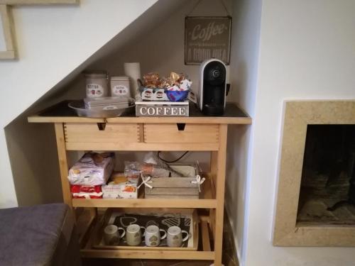 a shelf under the stairs with coffee on it at Sassi Sotto Le Stelle in Matera