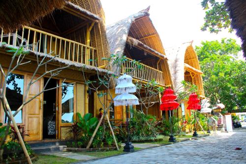 a building with red and white lanterns on a street at Beachouse Lovina in Lovina