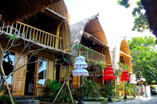 a building with red and white decorations on it at Beachouse Lovina in Lovina