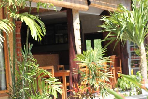 a group of plants in front of a restaurant at Beachouse Lovina in Lovina