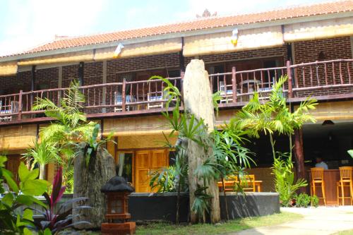 a building with a fountain in front of it at Beachouse Lovina in Lovina