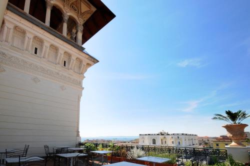 a view from the balcony of a building with tables and chairs at Villa Battista in Ercolano
