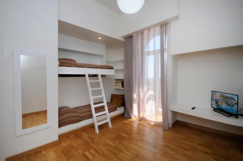 a room with a bunk bed and a ladder at Villa Battista in Ercolano