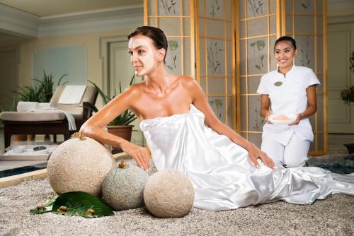 a woman in a white dress sitting on the floor with another woman at Abano Grand Hotel in Abano Terme