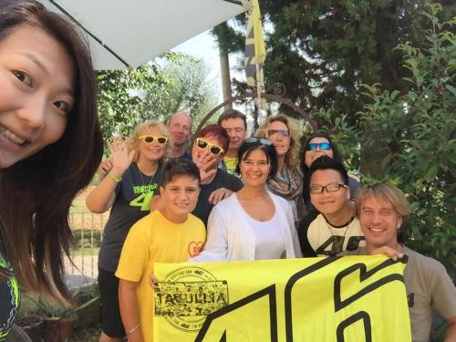 a group of people posing for a picture with a sign at B&B Il Giardino in Tavullia