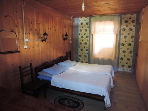 a bedroom with two beds and a window at Guesthouse Angelina in Ushguli