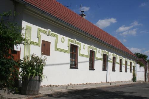 a white building with windows and a red roof at Chalupa u studny in Lukov