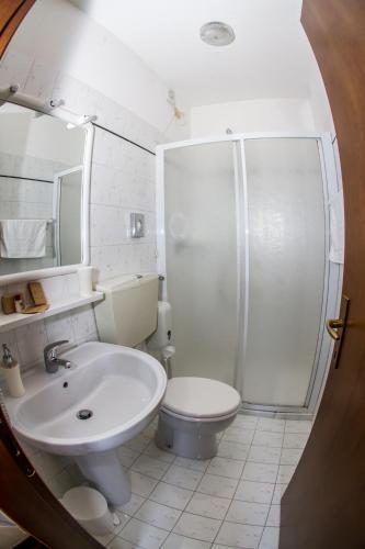 a bathroom with a sink and a toilet and a shower at Agriturismo Ca' Alleata in Caorle