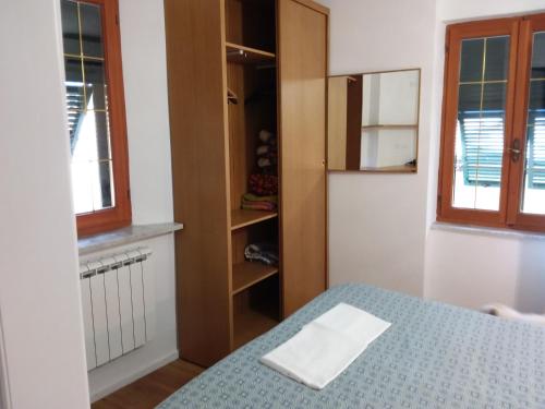 a bedroom with a bed and a book shelf at Rina Rooms in Vernazza