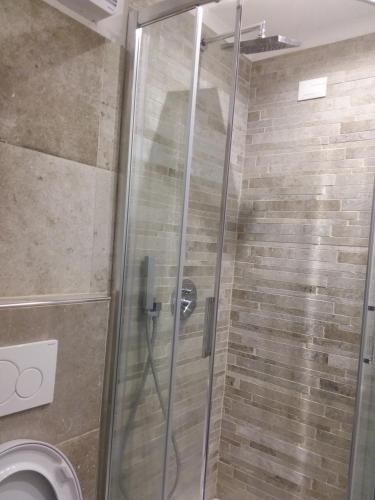 a shower with a glass door in a bathroom at Rina Rooms in Vernazza