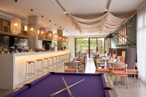 a pool table in a restaurant with a bar at AQUA Hotel Bertran Park in Lloret de Mar