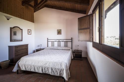En eller flere senge i et værelse på Agriturismo Il Giriatello