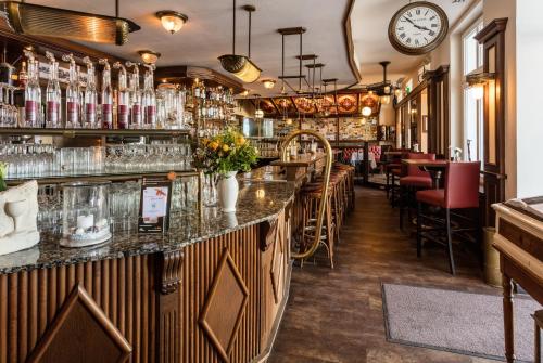 a bar in a restaurant with a clock on the wall at Villa Salve in Binz