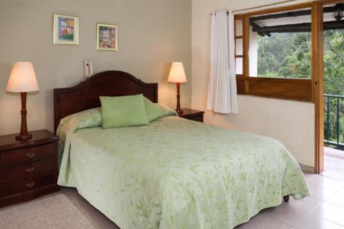 Postel nebo postele na pokoji v ubytování Hotel Campestre Los Arrayanes