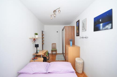 a bedroom with a bed and a desk and a table at Sunshine Apartment in Split