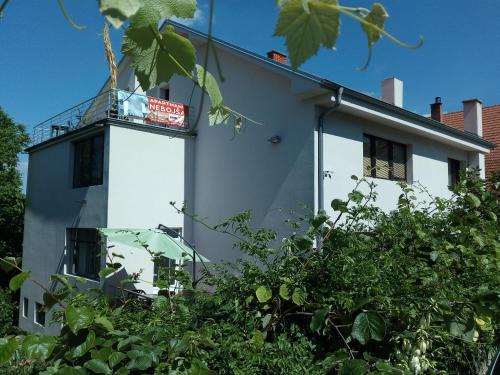 a white building with a sign on top of it at Apartments Nebojša in Soko Banja