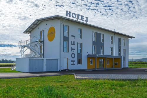 a large building with a sign on top of it at Hotel Tullnerfeld in Tulln