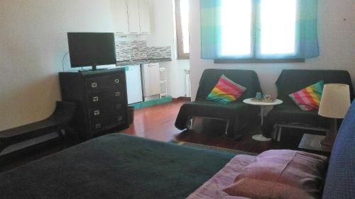 a living room with two chairs and a television at B&B Villa Patrizia in Ercolano