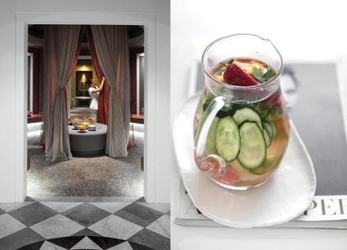 a glass vase filled with fruit on a plate at Grand Hotel Trieste & Victoria in Abano Terme