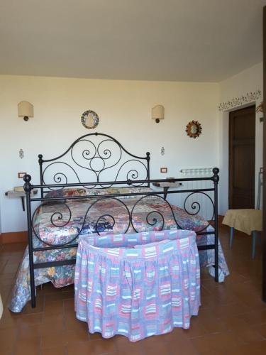 a bed with a bunch of water bottles on it at Poggio Bicchieri in Campiglia dʼOrcia