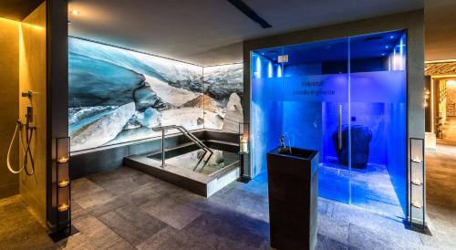 a exhibit in a museum with a large painting on the wall at DAS GERSTL Alpine Retreat in Malles Venosta