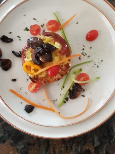 a white plate with a piece of food on it at Villa Majestic for Exclusive Accommodation in Port Alfred