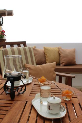 a wooden table with a tea set on top of it at Pedieos Guest House in North Nicosia