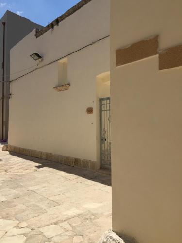 a white wall with a door and a patio at Borgo Sofia Bed and Breakfast in Mesagne