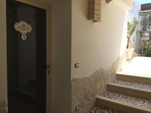a black door with stairs next to a building at Borgo Sofia Bed and Breakfast in Mesagne