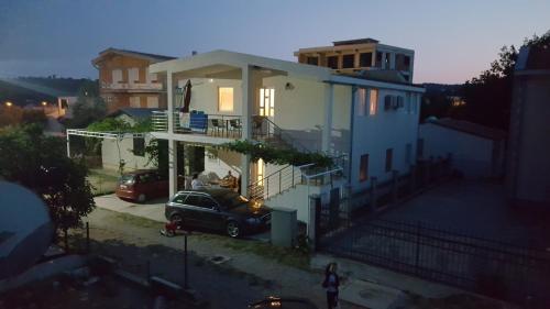 a house with a car parked in front of it at Apartment Djokic in Sutomore