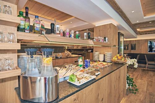 a kitchen with a counter with food on it at Hotel Gruenberger in Berchtesgaden