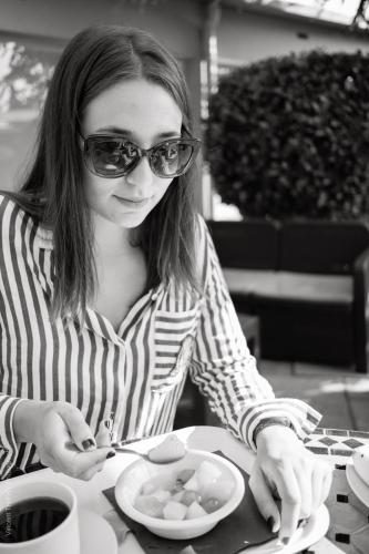 a woman sitting at a table with a plate of food at Logis Hôtel Atrium Epinal Golbey in Épinal