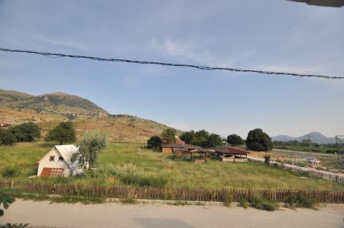 a group of houses on a hill next to a field at Elite Apart Pansiyon in Gokceada Town