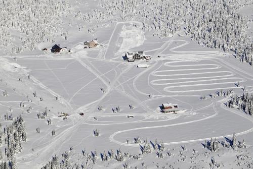 a group of people on a ski slope in the snow at Moravská Bouda in Špindlerův Mlýn