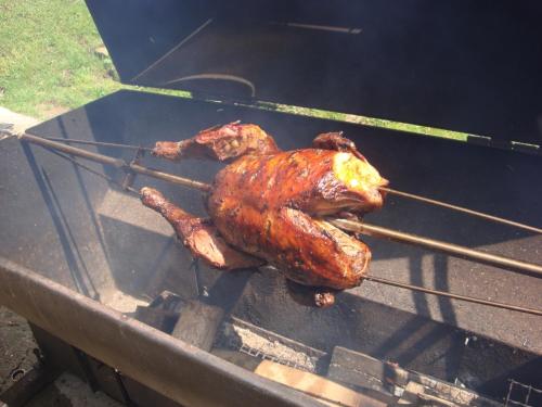 a chicken is being grilled on a grill at Moravská Bouda in Špindlerův Mlýn