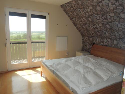 a bedroom with a bed and a stone wall at Haus Trappiste FOR FAMILIES ONLY NON SMOKING !! AIRCO ! in Donnerskirchen