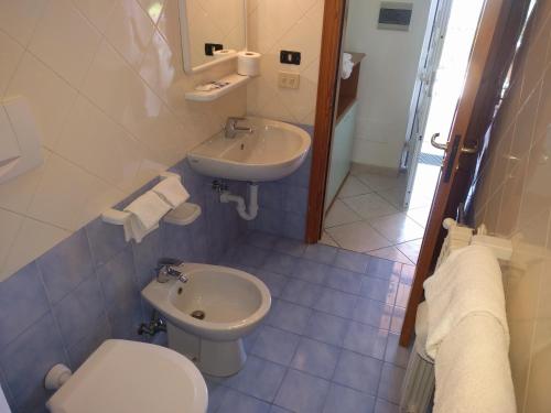 a bathroom with a toilet and a sink at Residence Giardino del Sole in Ischia