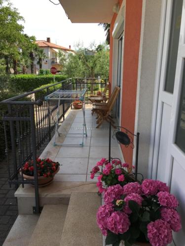 a balcony with flowers on the side of a building at Apartments Nina in Umag