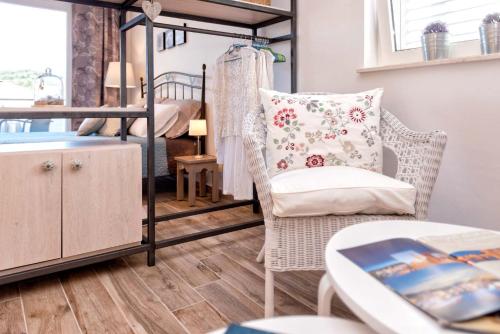 a living room with a chair and a bunk bed at Anchor Apartments in Stari Grad