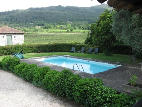 a swimming pool in the middle of a yard at Quinta de S.Vicente in Geraz do Minho