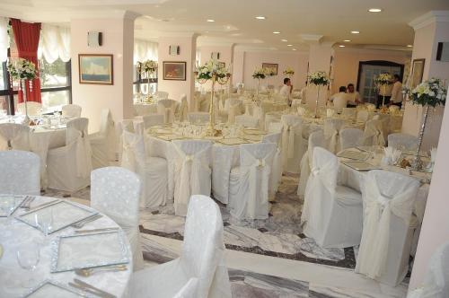 a room full of tables and chairs with white table cloth at Bugday Hotel in Ankara