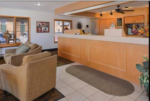 a lobby with a bar with two chairs and a counter at Americas Best Value Inn & Suites; Atlantic Inn & Suites in Atlantic